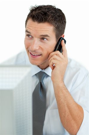 simsearch:400-04608943,k - Smiling businessman on phone working at a computer Stock Photo - Budget Royalty-Free & Subscription, Code: 400-04184816