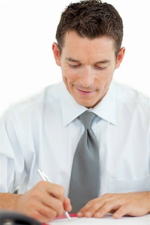 simsearch:400-05137517,k - Portrait of a smiling businessman writing at his desk Foto de stock - Super Valor sin royalties y Suscripción, Código: 400-04184819