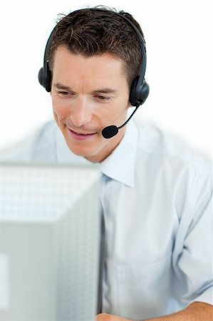 simsearch:400-04129170,k - Businessman with headset on working at a computer isolated on a white background Fotografie stock - Microstock e Abbonamento, Codice: 400-04184812