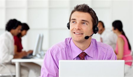 Smiling businessman talking on headset in the office Stock Photo - Budget Royalty-Free & Subscription, Code: 400-04184877