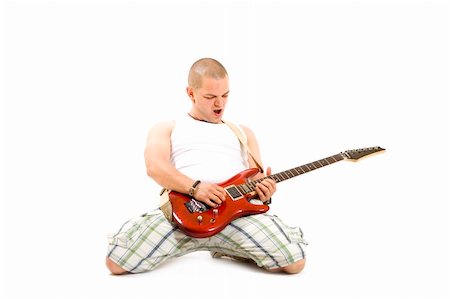 simsearch:400-08138723,k - excited young man playing a guitar isolated against white background Stock Photo - Budget Royalty-Free & Subscription, Code: 400-04184941