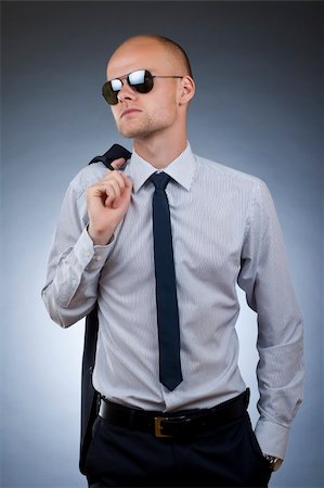 simsearch:400-04173630,k - young businessman with coat on shoulder looking away Stock Photo - Budget Royalty-Free & Subscription, Code: 400-04184983