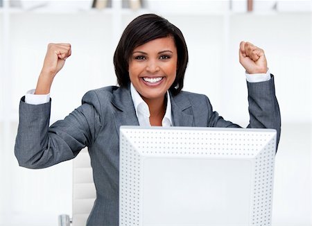simsearch:400-04187842,k - Confident businesswoman punching the air in celebration in the office Stock Photo - Budget Royalty-Free & Subscription, Code: 400-04185700