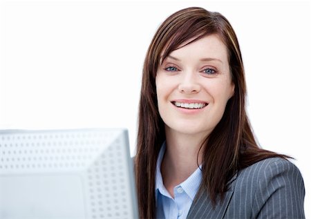 simsearch:400-04187842,k - Charismatic businesswoman working at a computer against a white background Stock Photo - Budget Royalty-Free & Subscription, Code: 400-04185712