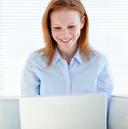 simsearch:400-04187842,k - Joyful business woman working on a laptop computer in the office Stock Photo - Budget Royalty-Free & Subscription, Code: 400-04185749