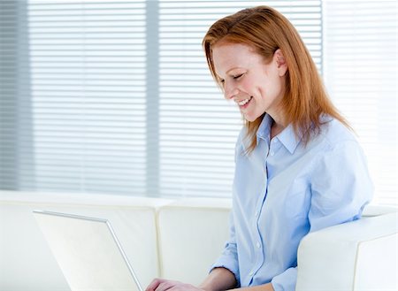 simsearch:400-04187842,k - Happy business woman working on a laptop computer in the office Stock Photo - Budget Royalty-Free & Subscription, Code: 400-04185742