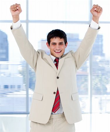 person punching for victory - Cheerful businessman punching the air in celebration in the office Stock Photo - Budget Royalty-Free & Subscription, Code: 400-04185804