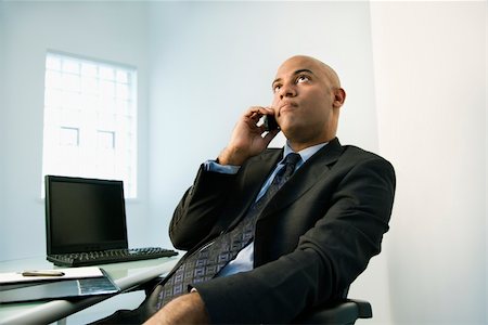 simsearch:400-04186486,k - African American businessman holding cellphone to ear looking bored. Stock Photo - Budget Royalty-Free & Subscription, Code: 400-04186190
