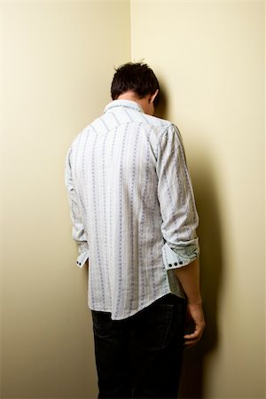 Young man standing with head in corner. Stock Photo - Budget Royalty-Free & Subscription, Code: 400-04186412