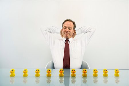 simsearch:400-04186486,k - Portrait of middle aged  Caucasian businessman sitting at desk with ducks in a row. Stock Photo - Budget Royalty-Free & Subscription, Code: 400-04186446