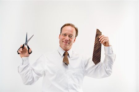 simsearch:400-04186486,k - Caucasian middle aged businessman cutting off necktie with scissors. Stock Photo - Budget Royalty-Free & Subscription, Code: 400-04186489
