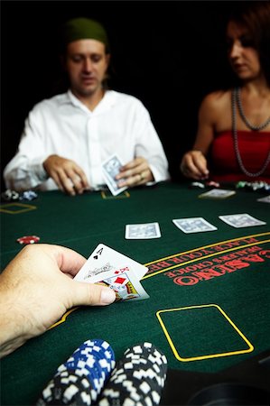 Ace of clubs and King of Diamonds in hand in a poker hand with high value chips on the table Stock Photo - Budget Royalty-Free & Subscription, Code: 400-04186742