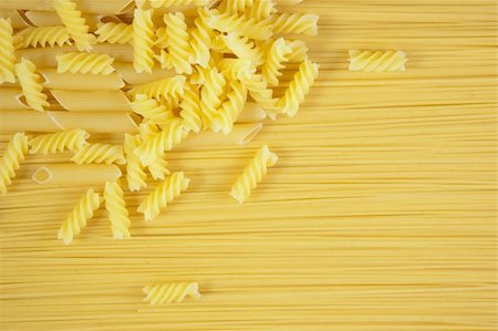 simsearch:400-05270612,k - Background of Macaroni on long spaghetti. Close up . Photographie de stock - Aubaine LD & Abonnement, Code: 400-04186883