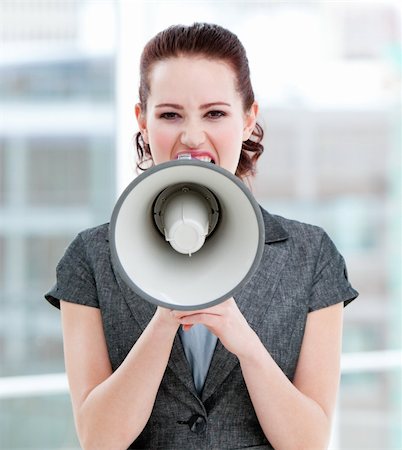 simsearch:400-04126489,k - Furious businesswoman yelling through a megaphone standing in the office Stock Photo - Budget Royalty-Free & Subscription, Code: 400-04186925