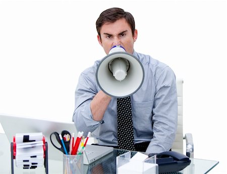 simsearch:400-06763387,k - Furious businessman yelling through a megaphone sitting at his desk in the office Stock Photo - Budget Royalty-Free & Subscription, Code: 400-04186931