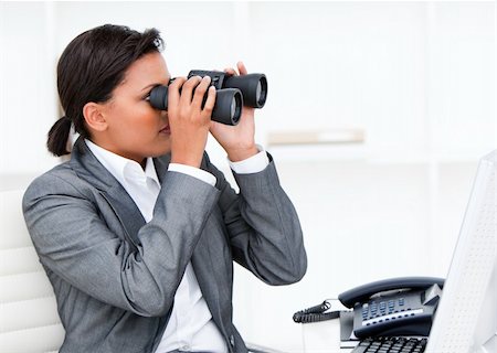 Self-assured businesswoman looking through binoculars in the office Stock Photo - Budget Royalty-Free & Subscription, Code: 400-04186953