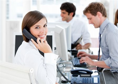 simsearch:400-04187842,k - Smiling businesswoman talking to the phone in the open-space Stock Photo - Budget Royalty-Free & Subscription, Code: 400-04187028