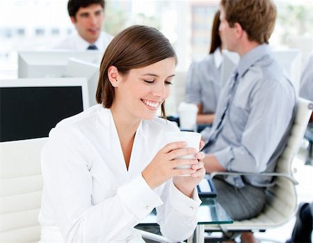 simsearch:400-04187842,k - Smiling businesswoman holding a cup of coffee in the office Stock Photo - Budget Royalty-Free & Subscription, Code: 400-04187039