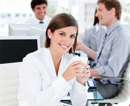 simsearch:400-04187842,k - Smiling businesswoman holding a cup of tea in the office Stock Photo - Budget Royalty-Free & Subscription, Code: 400-04187040