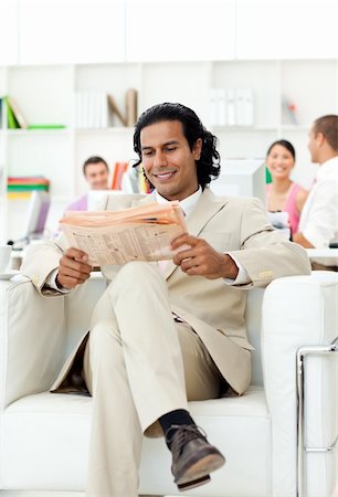 Smiling manager reading a newspaper in the office Stock Photo - Budget Royalty-Free & Subscription, Code: 400-04187089
