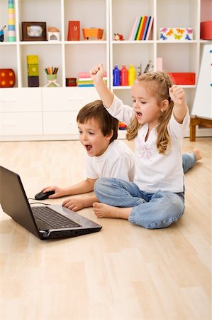 Stressed or excited kids about to win computer game Stock Photo - Budget Royalty-Free & Subscription, Code: 400-04187568