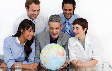 simsearch:400-04187718,k - Smiling business people looking at a terrestrial globe in the office Foto de stock - Royalty-Free Super Valor e Assinatura, Número: 400-04187717