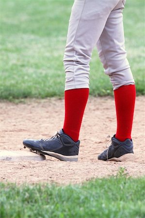 sock foot shoe - Close up of baseball player's legs with bright red stockings as he stands on first base Stock Photo - Budget Royalty-Free & Subscription, Code: 400-04187729