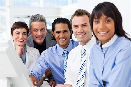 simsearch:400-05009097,k - Multi-ethnic smiling business team sitting in a row in the office Stock Photo - Budget Royalty-Free & Subscription, Code: 400-04187722