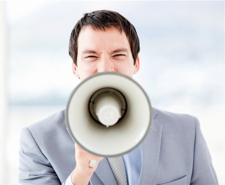 simsearch:400-04126489,k - Portrait of an stressed businessman using a megaphone in the office Stock Photo - Budget Royalty-Free & Subscription, Code: 400-04187788