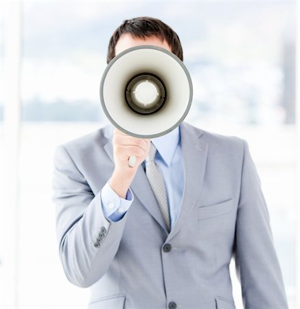 simsearch:400-04126489,k - Portrait of an young businessman using a megaphone in the office Stock Photo - Budget Royalty-Free & Subscription, Code: 400-04187790