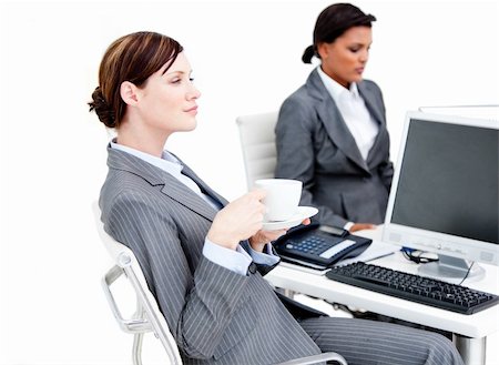 simsearch:400-04187842,k - Busy female business partners drinking coffee while having a break in the office Stock Photo - Budget Royalty-Free & Subscription, Code: 400-04187839