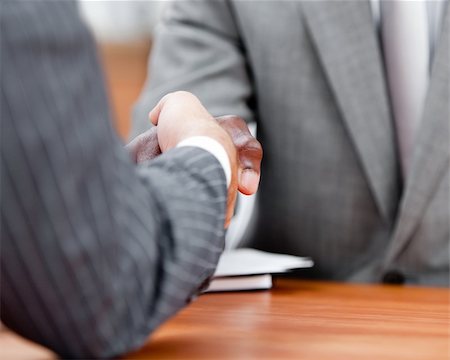 simsearch:400-08289045,k - Close-up of a handshake between two differents businessmen in the office Stock Photo - Budget Royalty-Free & Subscription, Code: 400-04187853