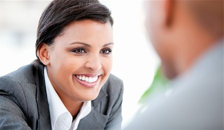 simsearch:400-05242665,k - Portrait of a smiling businesswoman talking with her colleague in the office Foto de stock - Super Valor sin royalties y Suscripción, Código: 400-04187890