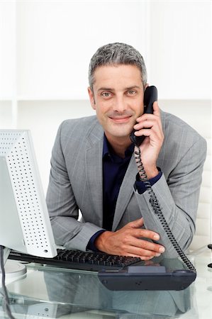 simsearch:400-05900712,k - Self-assured businessman on phone at his desk in the office Stock Photo - Budget Royalty-Free & Subscription, Code: 400-04187988