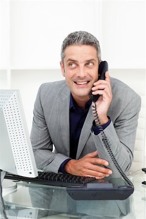 simsearch:400-05900712,k - Attractive businessman on phone at his desk in the office Stock Photo - Budget Royalty-Free & Subscription, Code: 400-04187989