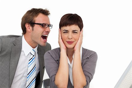 Stressed businessman shouting into his colleague's ear in the office Stock Photo - Budget Royalty-Free & Subscription, Code: 400-04188004