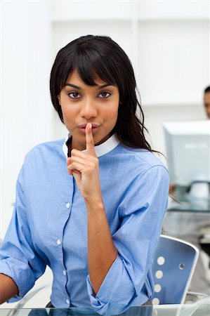 shushing girl - Ethnic businesswoman asking for silence in the office Stock Photo - Budget Royalty-Free & Subscription, Code: 400-04188093