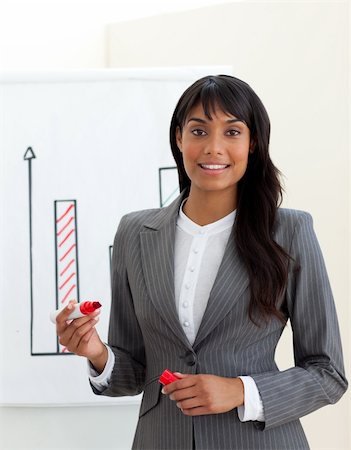 public talk - Ethnic young businesswoman reporting sales figures isolated on a white background Photographie de stock - Aubaine LD & Abonnement, Code: 400-04188128