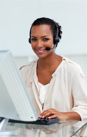 simsearch:400-04188205,k - Afro-american businesswoman with headset on working at a computer in a call-center Stock Photo - Budget Royalty-Free & Subscription, Code: 400-04188204