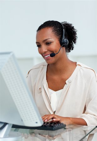 simsearch:400-04188205,k - Cheerful businesswoman with headset on working at a computer in a call-center Stock Photo - Budget Royalty-Free & Subscription, Code: 400-04188205