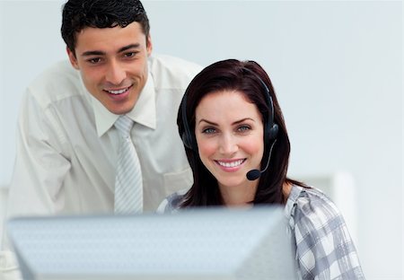 simsearch:400-04188205,k - Latin businessman helping his colleague at a computer Stock Photo - Budget Royalty-Free & Subscription, Code: 400-04188211