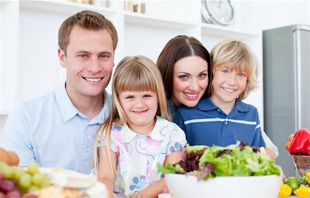 simsearch:400-04206231,k - Attentive parents and their children cooking together in the kitchen Stock Photo - Budget Royalty-Free & Subscription, Code: 400-04188230