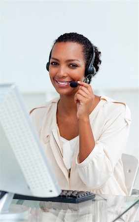 simsearch:400-04188205,k - Charming businesswoman with headset on working at a computer Stock Photo - Budget Royalty-Free & Subscription, Code: 400-04188452