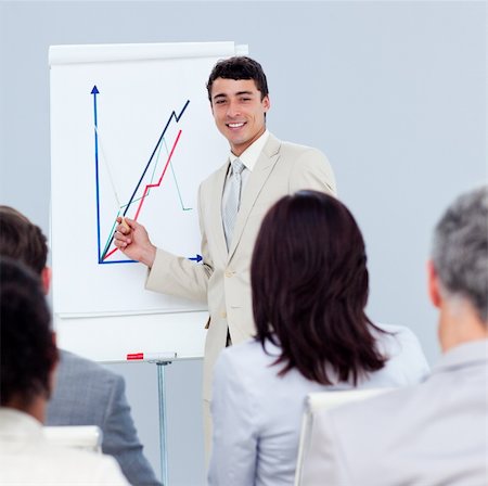 simsearch:400-04184379,k - Positive young businessman doing a presentation to his colleagues Stock Photo - Budget Royalty-Free & Subscription, Code: 400-04188520