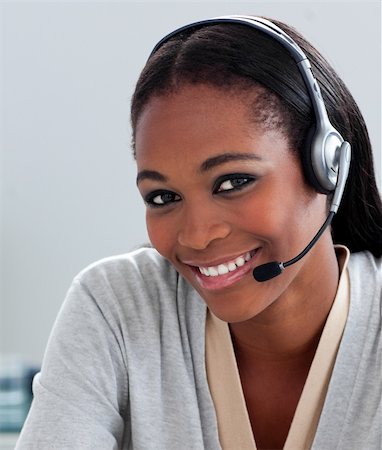 simsearch:400-03912315,k - Delighted Afro-american businesswoman using headset in the office Photographie de stock - Aubaine LD & Abonnement, Code: 400-04188671