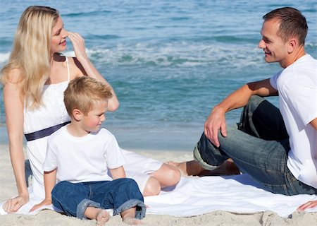 simsearch:400-04114591,k - Smiling parents with their son sitting on the sand at the beach Stock Photo - Budget Royalty-Free & Subscription, Code: 400-04188949