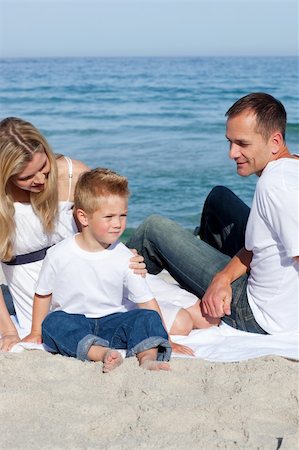 simsearch:400-04114591,k - Happy parents with their son sitting on the sand at the beach Stock Photo - Budget Royalty-Free & Subscription, Code: 400-04188951