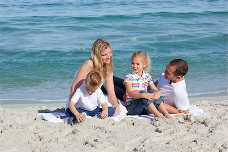 simsearch:400-04114591,k - Caring parents with their children sitting on the sand at the beach Stock Photo - Budget Royalty-Free & Subscription, Code: 400-04188964