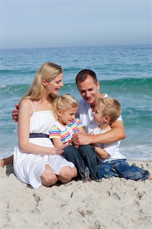 simsearch:400-05291156,k - Portrait of an affectionate family sitting on the sand at the beach Stock Photo - Budget Royalty-Free & Subscription, Code: 400-04188965