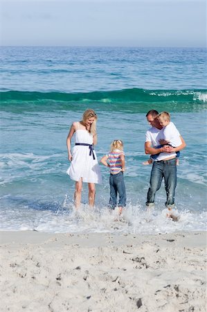 simsearch:400-04062793,k - Cheerful family having fun on the sand at the beach Photographie de stock - Aubaine LD & Abonnement, Code: 400-04188975